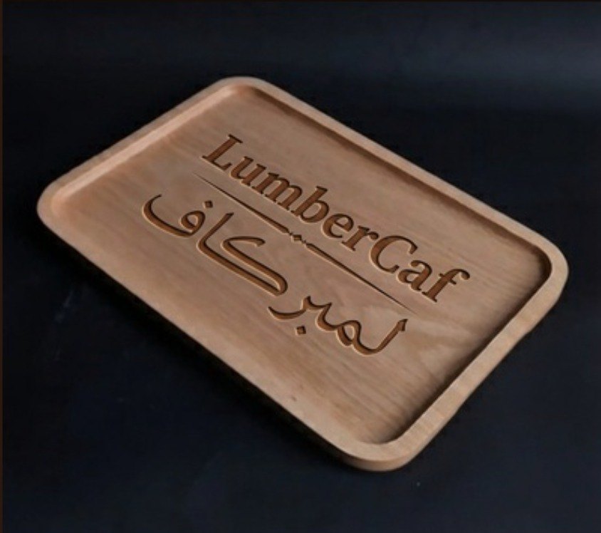 A tray with the LumberCaf name engraved in English and Arabic